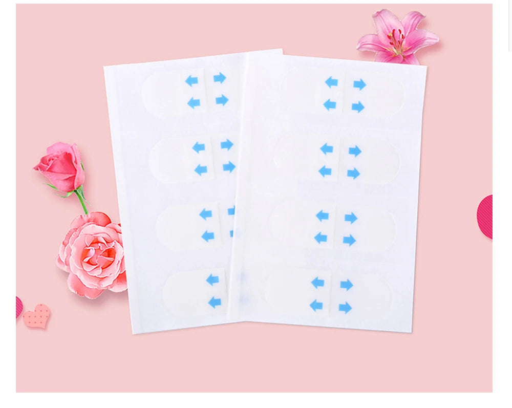 Clear eyelid tape strips on white backing sheets, used for creating a double eyelid effect.