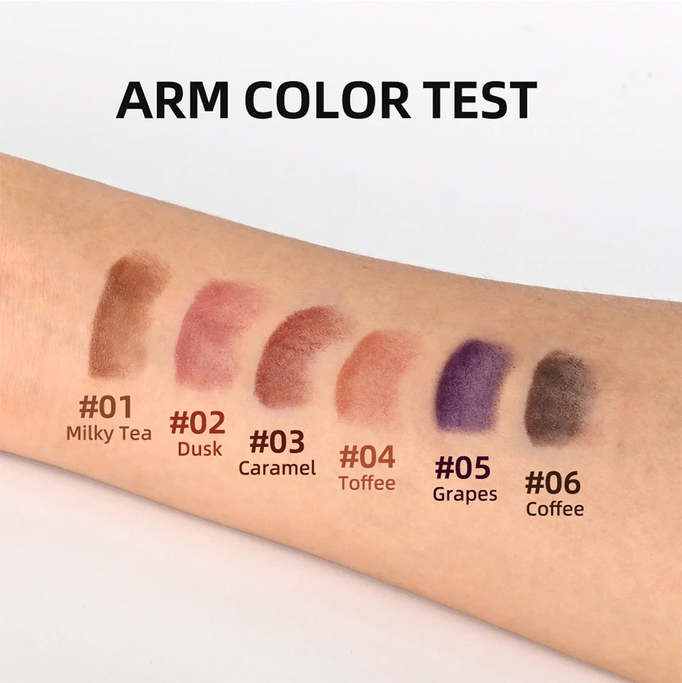 Swatches of 6 matte waterproof lipstick pencil shades in red, brown, and grape tones on a forearm.