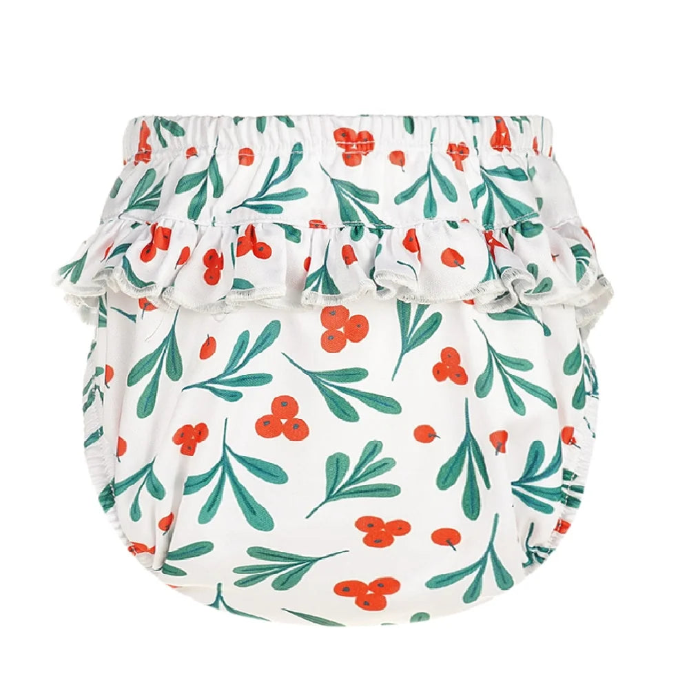 Baby care cloth diaper cover with white, red berry, and green leaf print and ruffled waist detail.