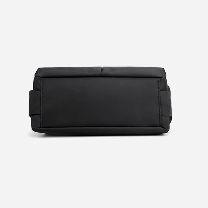 Minimalist black canvas designer handbag with a simple rectangular silhouette and solid color, casual daily satchel.
