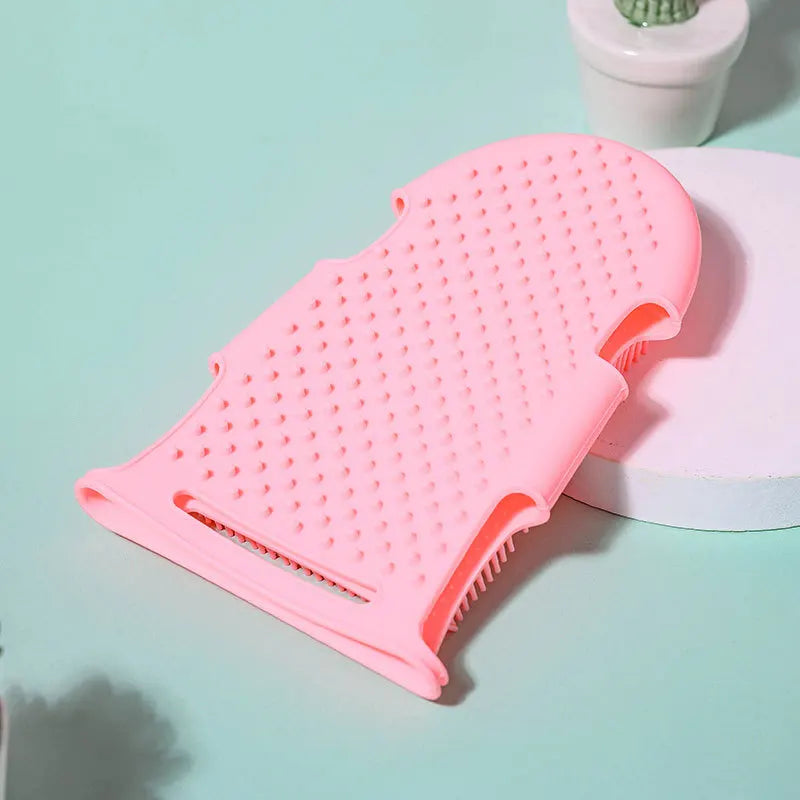 Pink silicone pet bath brush glove for gentle massage, grooming, and removing dead skin during dog and cat bathing.