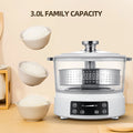 White electric rice cooker with glass lid, steaming basket, and control panel, front view.