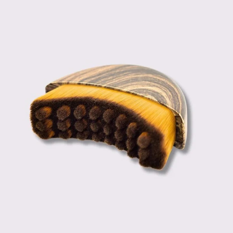 Soft fiber facial massage brush with wood-grain handle for lymphatic drainage, contouring, and depuffing.