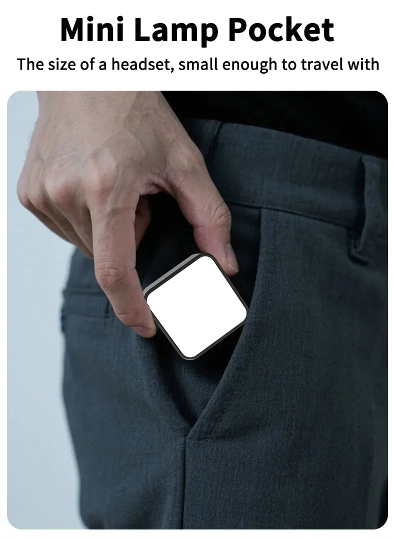 Small, square, black and white portable light fitting into a pants pocket for easy travel.
