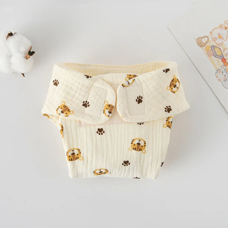 Cream-colored baby cloth diaper with tiger and paw print pattern, made of soft muslin cotton fabric.