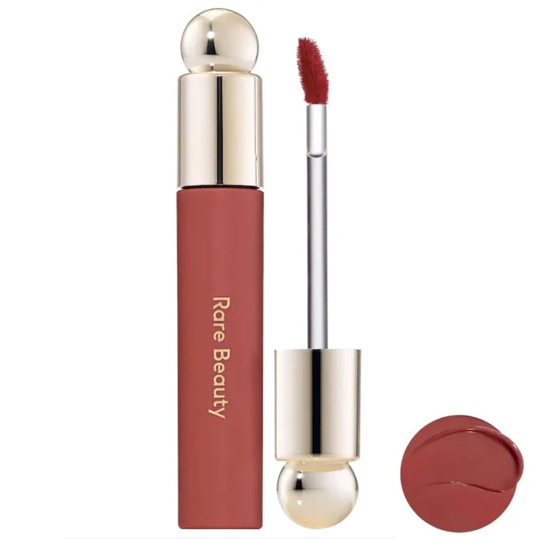 Rare Beauty Soft Pinch Tinted Lip Oil in a muted rose shade with applicator wand and glossy lip stain swatch.