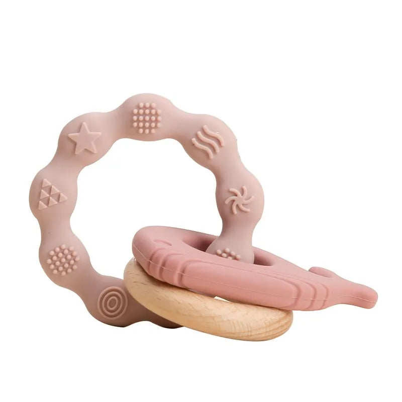 Pink silicone and wood baby teething ring toy for soothing sore gums.
