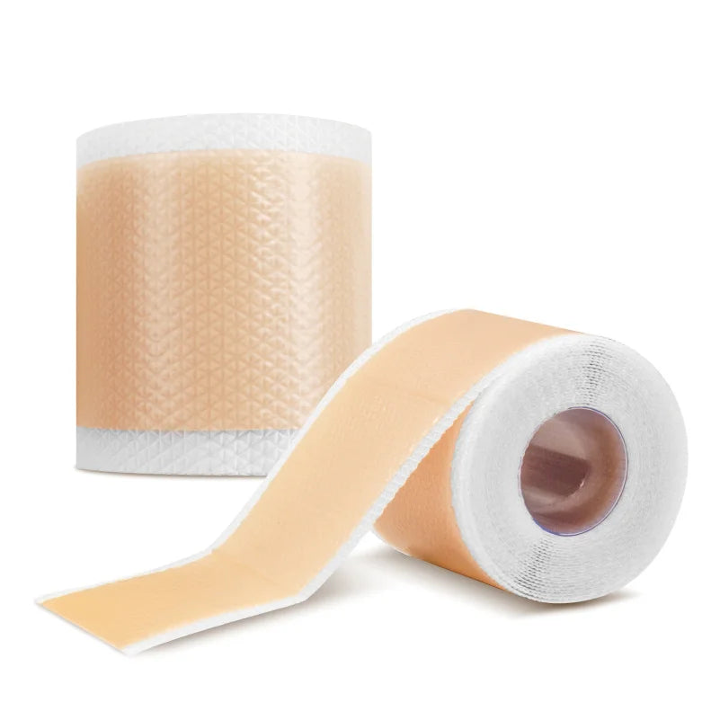 Roll of beige silicone scar sheets and self-adhesive tape for stretch mark removal and scar treatment.