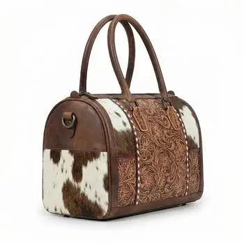 Genuine leather mini duffel trunk with floral tooling, cowhide panels, and brown accents for travel.