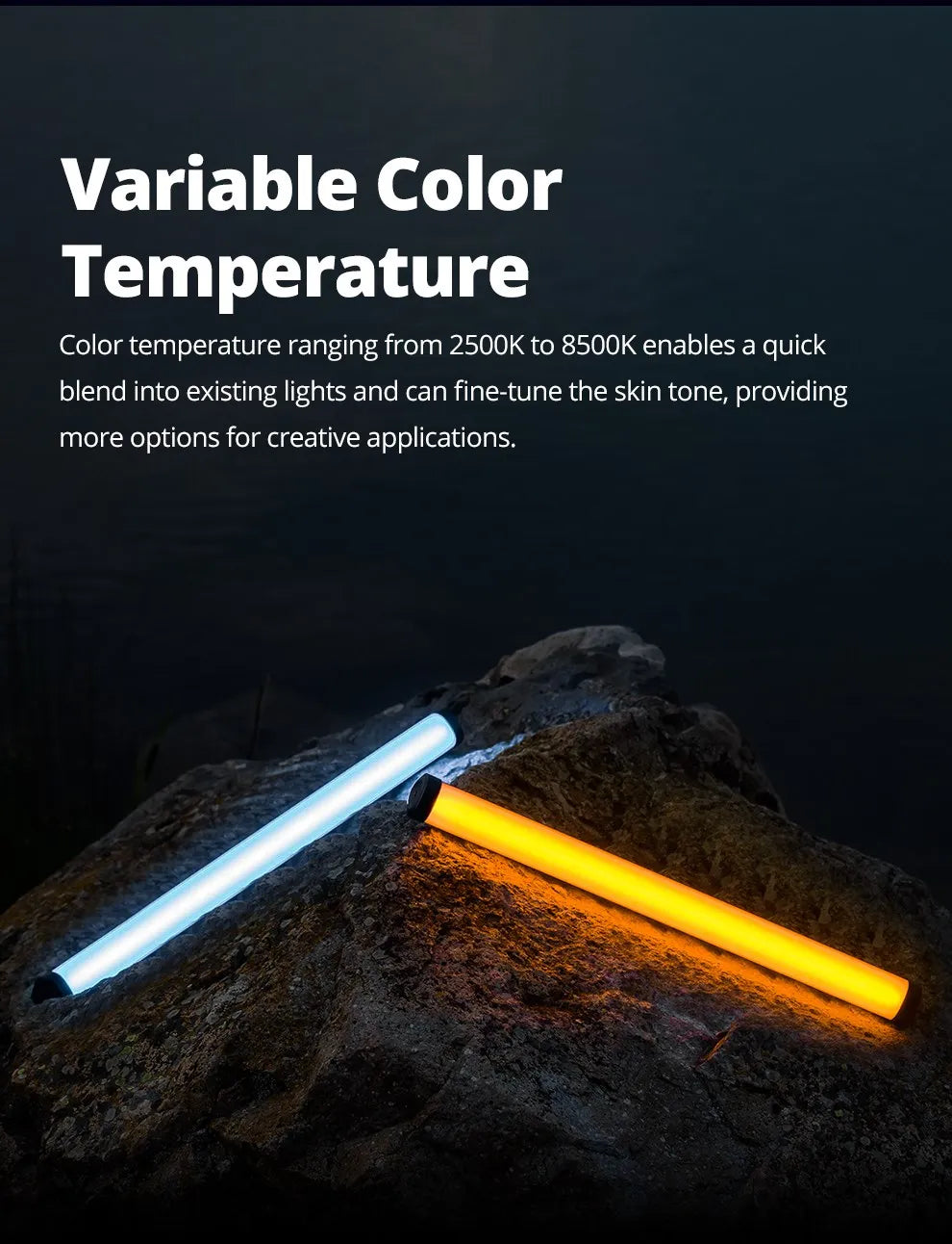 Two cylindrical LED light sticks, one cool white and one warm orange, resting on a dark rock for photography lighting.