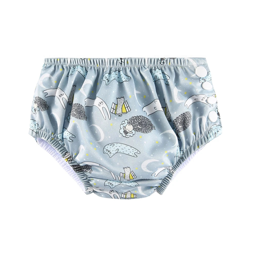 Reusable baby swim diaper in blue with cute sheep and moon print, side snap buttons for adjustable fit.