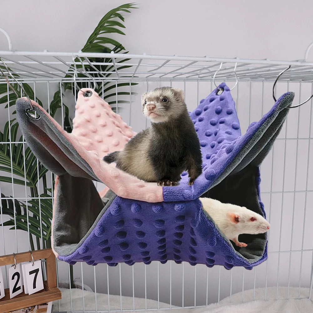 Cozy double-layer fleece hammock for ferrets and small pets in pink and purple, perfect for warm cage lounging.
