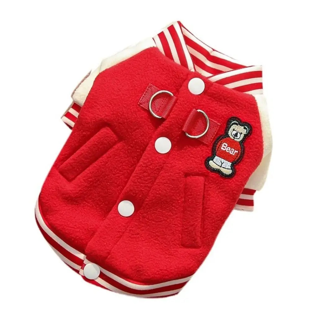 Red fleece winter puppy baseball jacket with D-ring harness, button closure, and bear patch for warm outdoor pet wear.