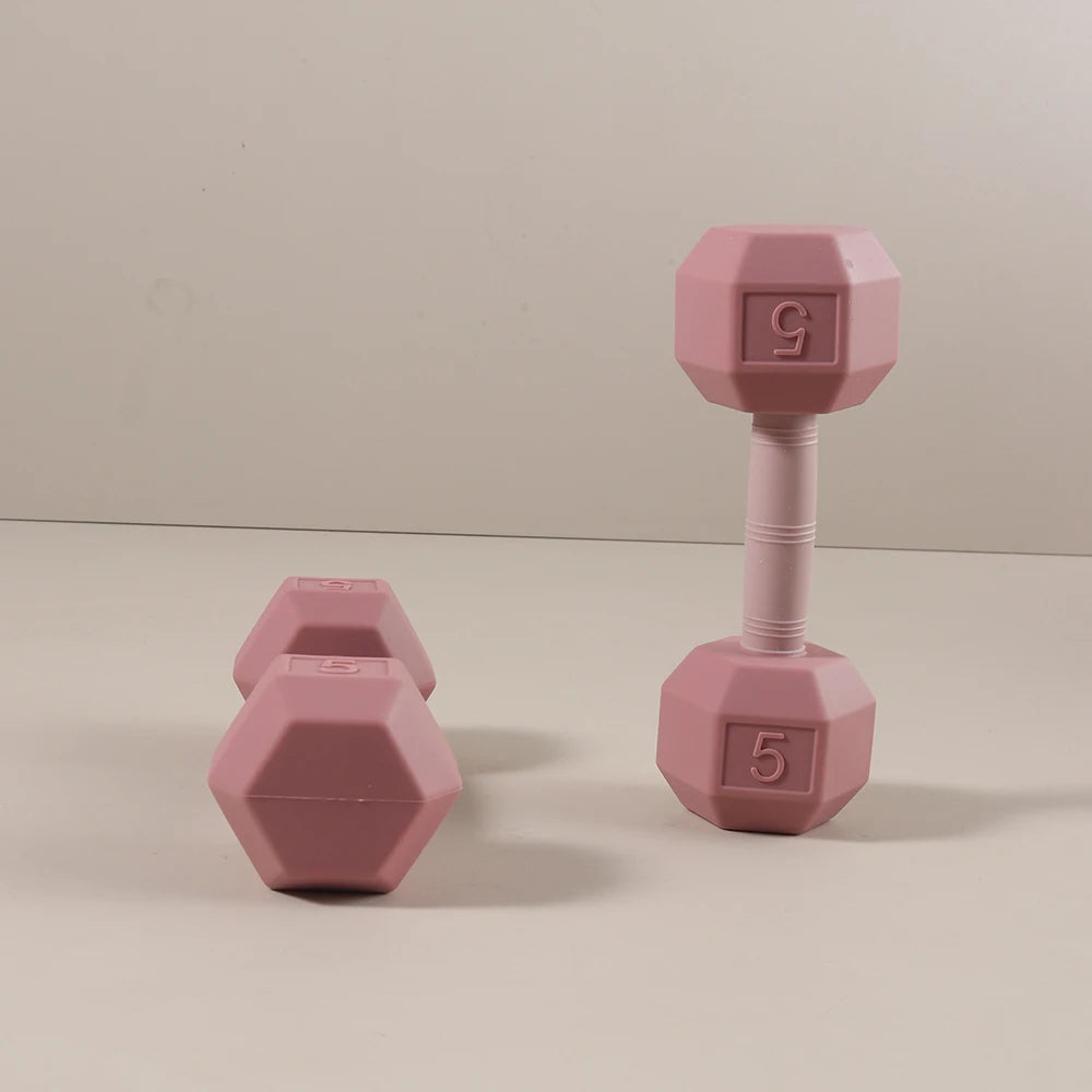 Pink silicone dumbbell baby teething toy for relief.