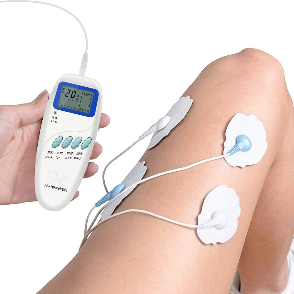White TENS unit electric muscle stimulator with digital screen and electrode pads applied to leg for pain relief.