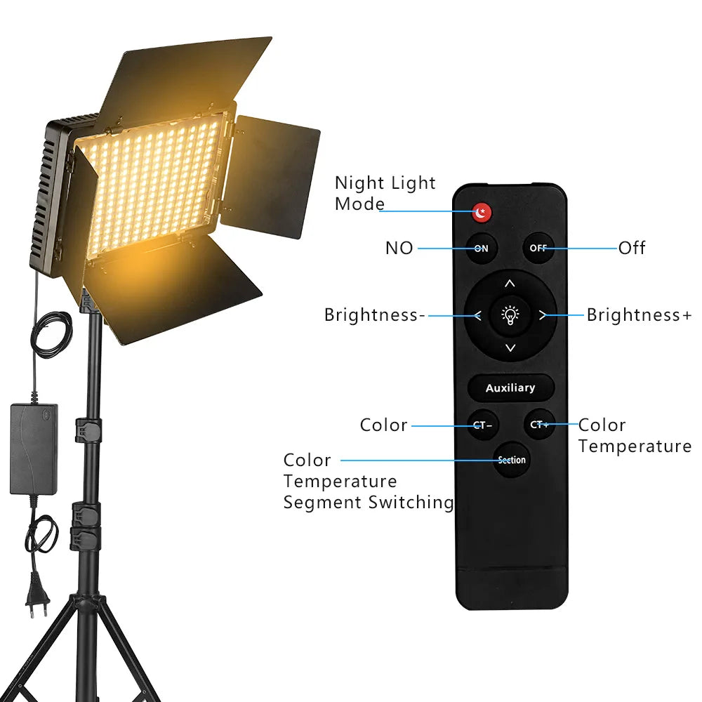 LED video light panel on a tripod stand with barn doors, warm glow, and a remote control for lighting adjustments.