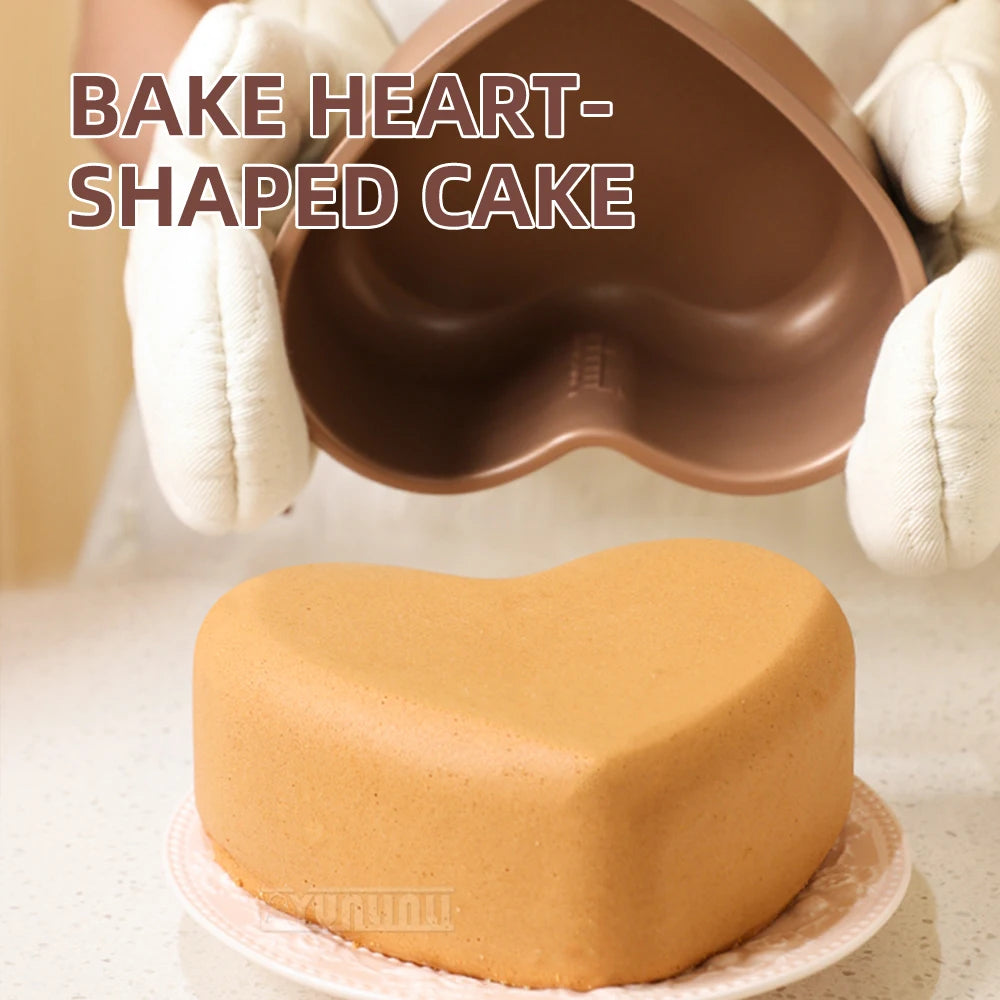 Heart-shaped baking insert tray for mini cooker, with tongs holding the mold