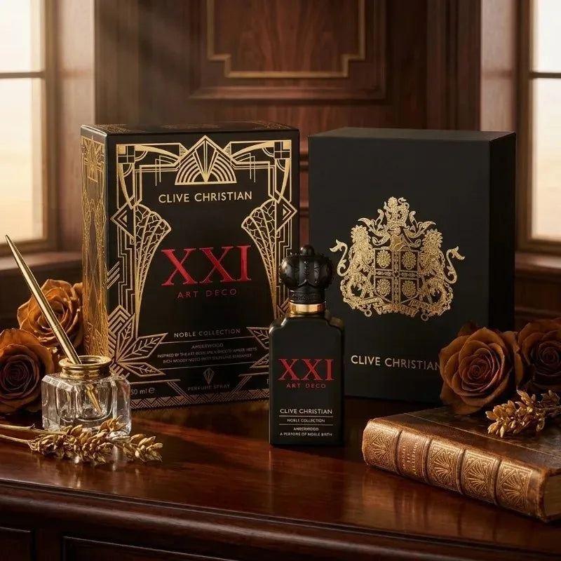 XXI Art Deco perfume in a black glass bottle with a crown cap, alongside its ornate black and gold display box.