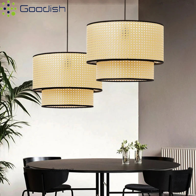 Two-tiered pendant lights with beige woven rattan shades and black trim, hanging over a dining table.