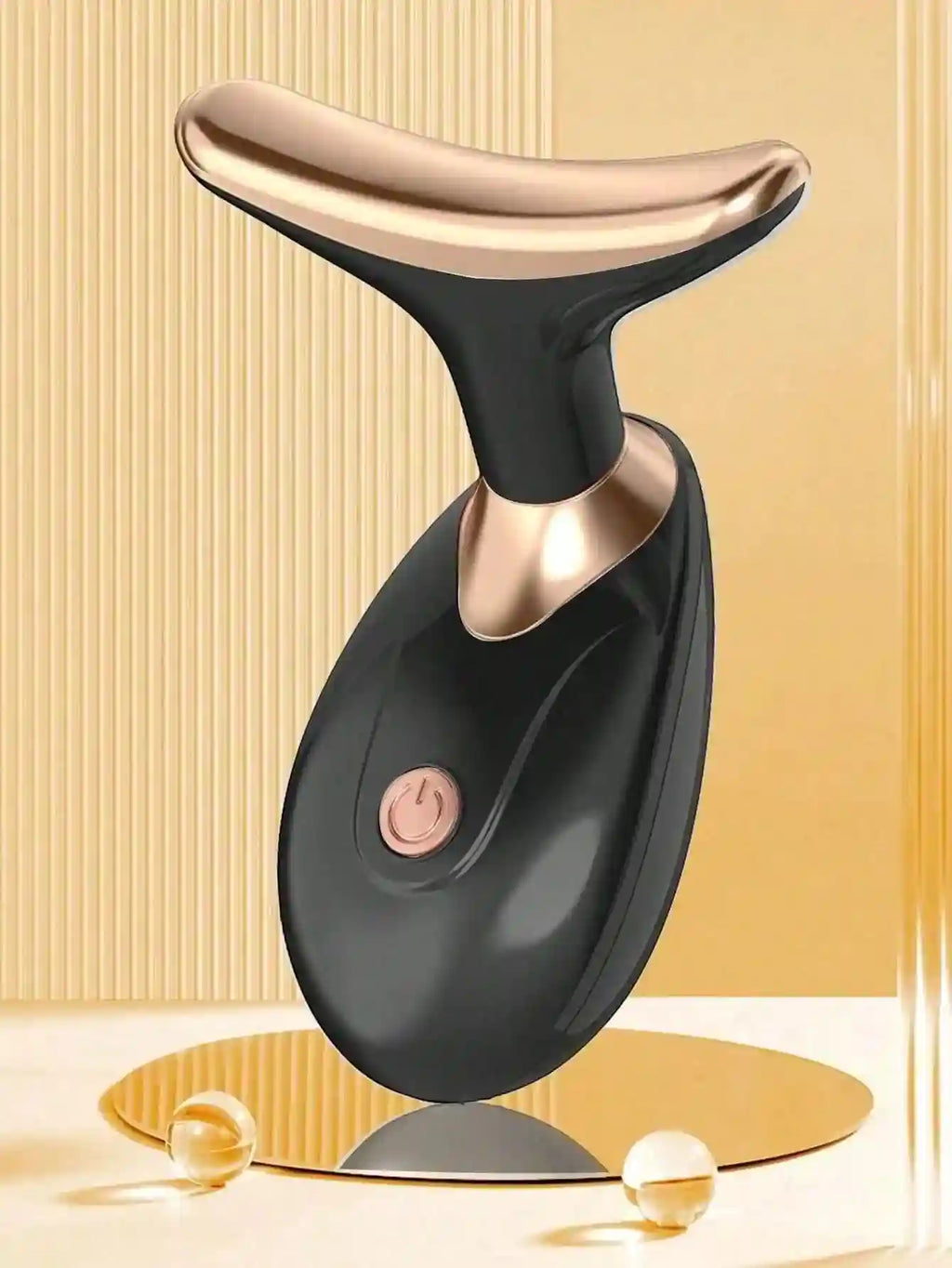 Black and rose gold, T-shaped facial massager with a smooth, ergonomic handle and a prominent power button.