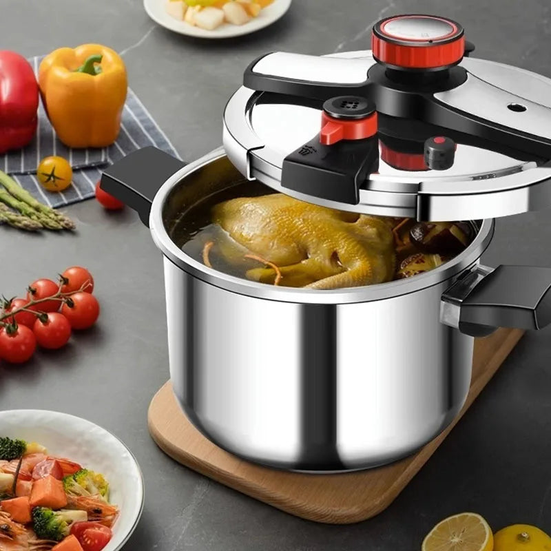 Stainless steel pressure cooker with lid closed, black handles, and food in inner pot