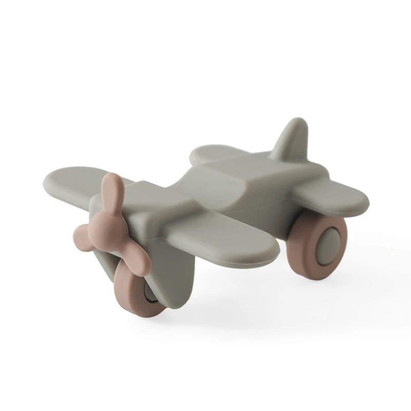 Sage green and tan silicone airplane baby teething toy.