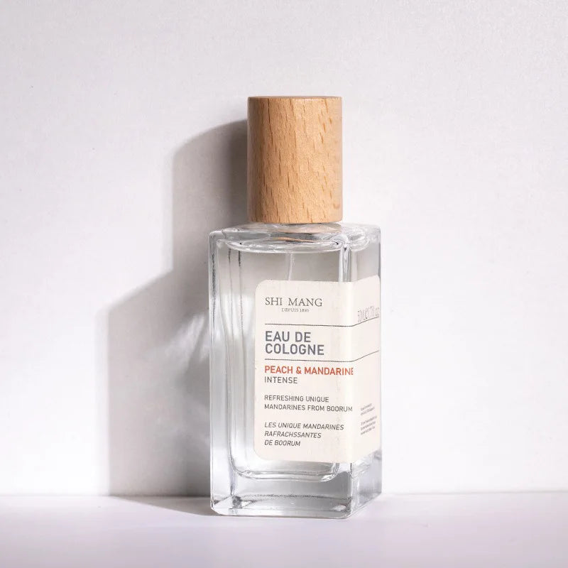 Shi Mang Peach & Mandarine Eau de Cologne: 50ml woody fruity fragrance, luxury clear glass bottle with wood cap.