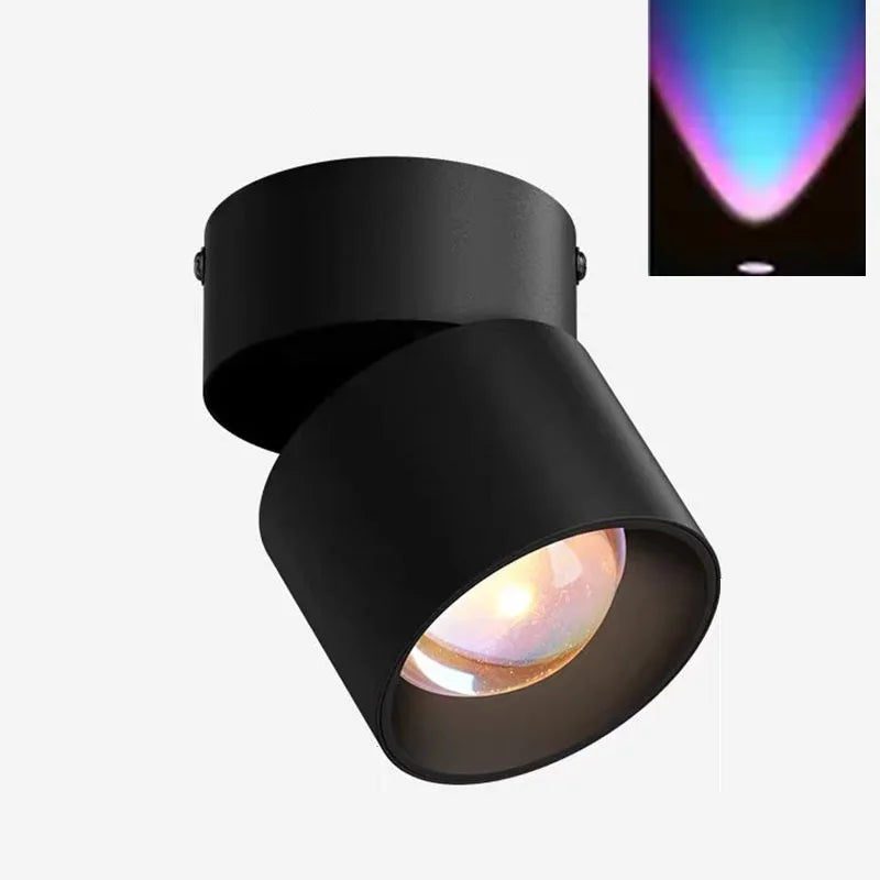 Black LED ceiling surface spotlight with angled cylindrical head and colorful light beam