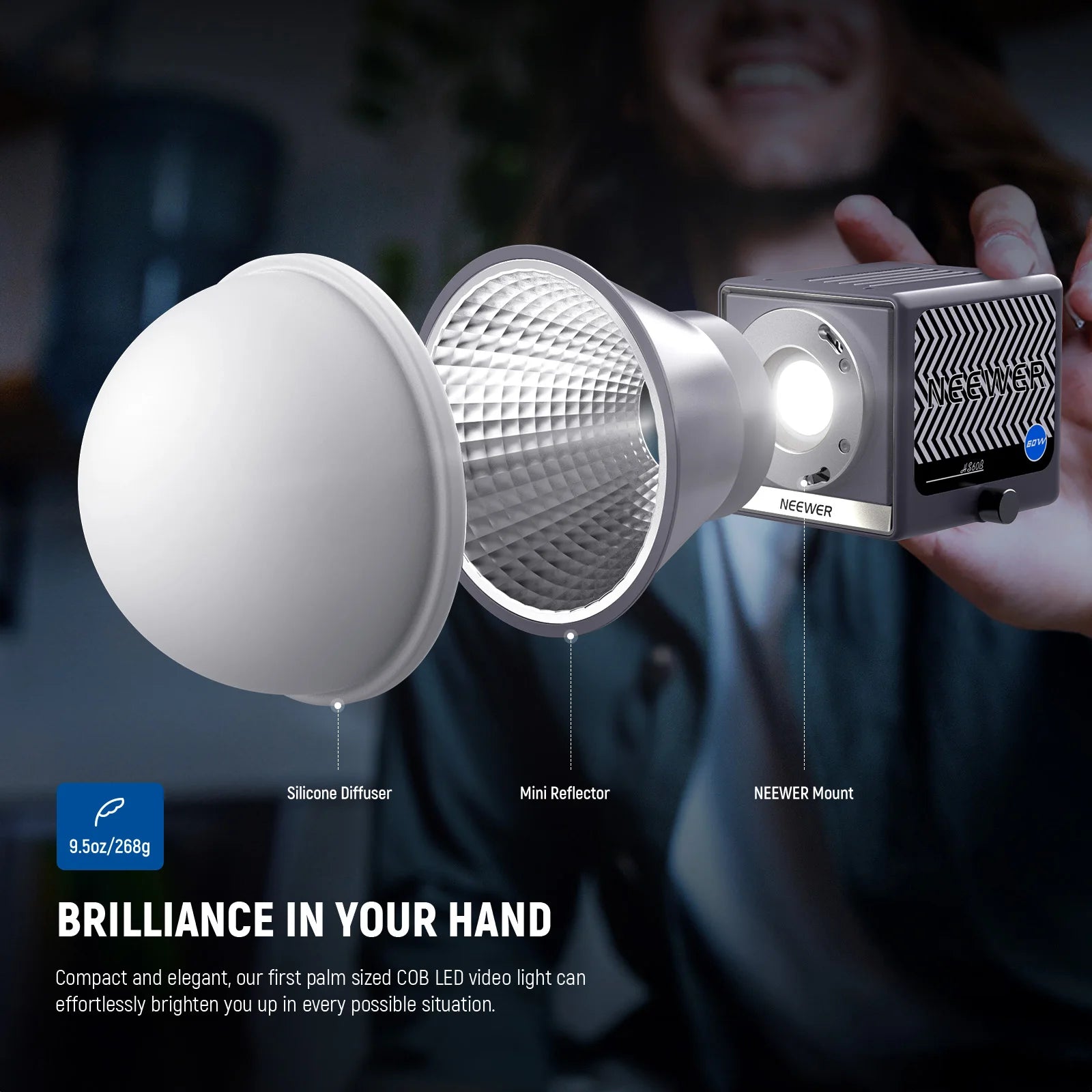 Palm-sized COB LED video light with a modular silver reflector and white silicone diffuser for portable lighting.