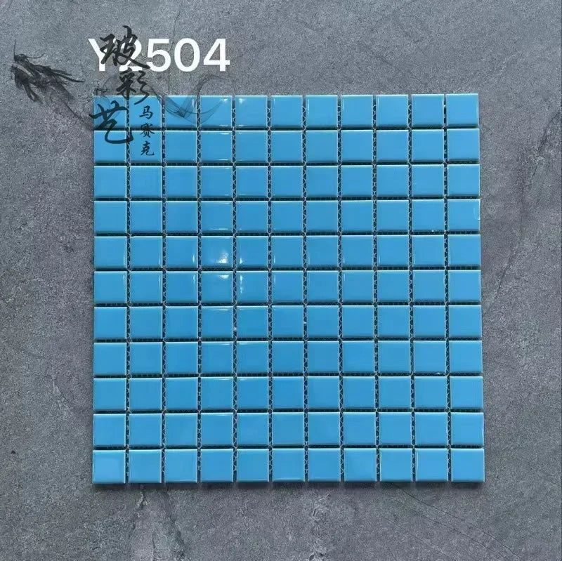 Ceramic mosaic tile sheet with light blue squares and dark grout lines