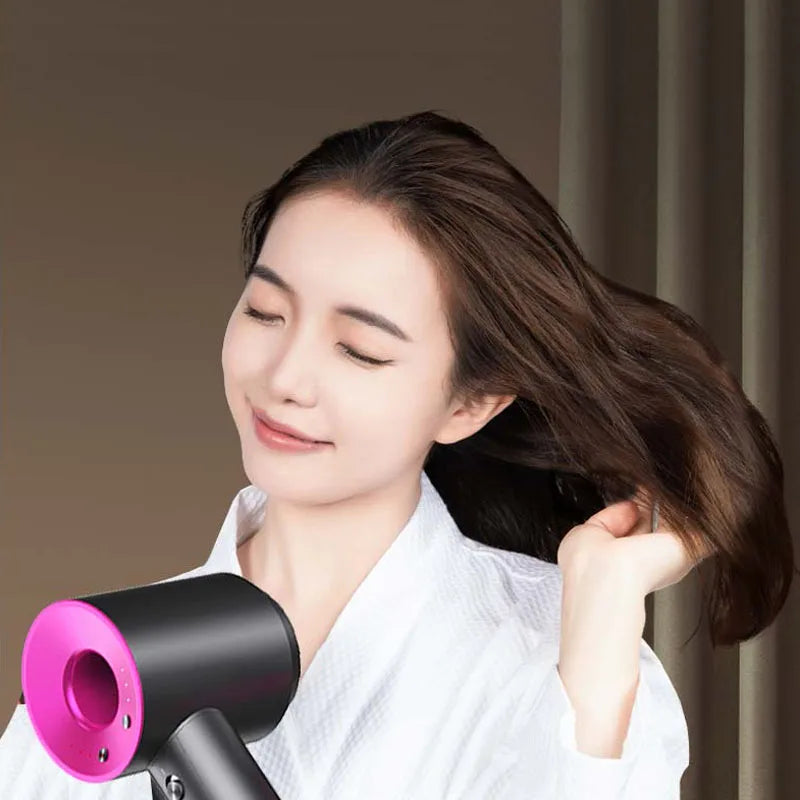 Black and pink 1600W high-speed ionic hair dryer styling hair for a professional salon finish at home.