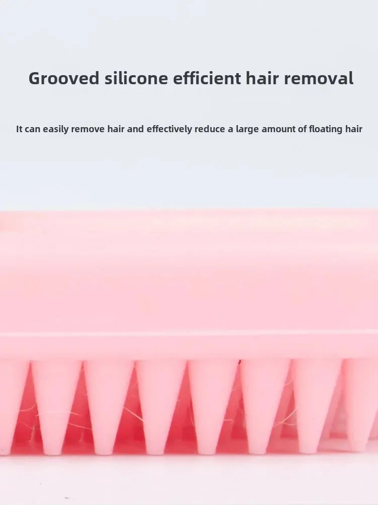 Pink silicone pet grooming brush for rabbits and cats. Efficient grooved design for removing loose fur and hair.