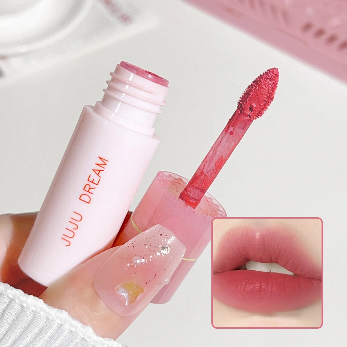 JUJU DREAM matte lip glaze in pink tube with velvet applicator and soft pink lip swatch. Non-stick long-lasting makeup.