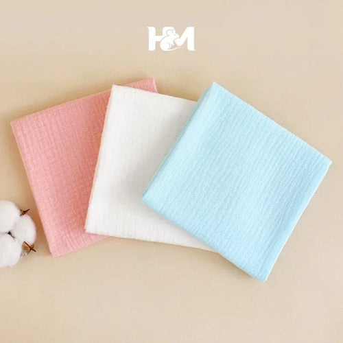 Set of 3 H&M muslin baby care washcloths in pink, white, and blue, soft cotton fabric for sensitive skin.