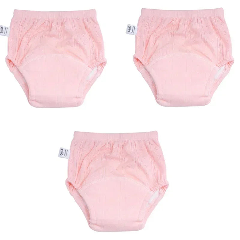 Three-pack of UOU pink reusable baby training diapers for potty training.