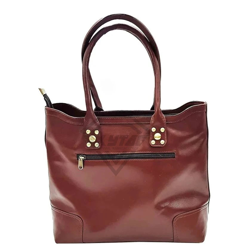 Burgundy cowhide leather tote bag with dual shoulder straps, gold stud accents, and external front zipper pocket.