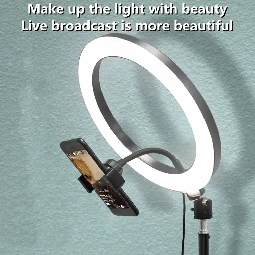 Circular LED ring light with a black adjustable smartphone holder mounted on a stand for filming and live streaming.