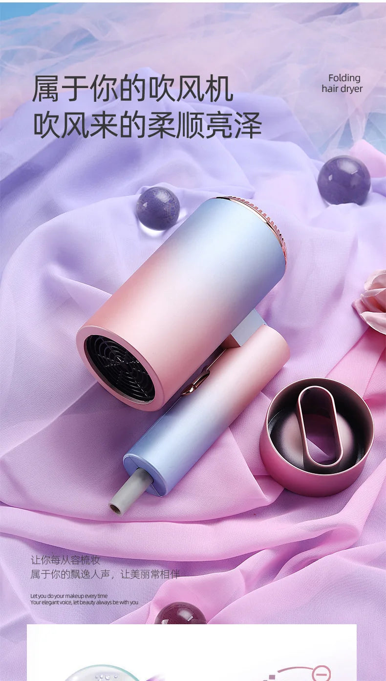 Foldable blue and pink gradient mini hair dryer with magnetic nozzle attachment for quick, ionic, quiet hair drying.
