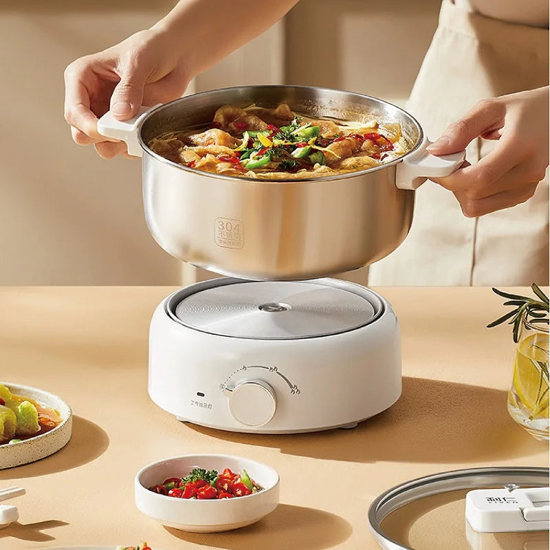 Portable electric cooking pot with stainless inner pot, glass lid, and white base