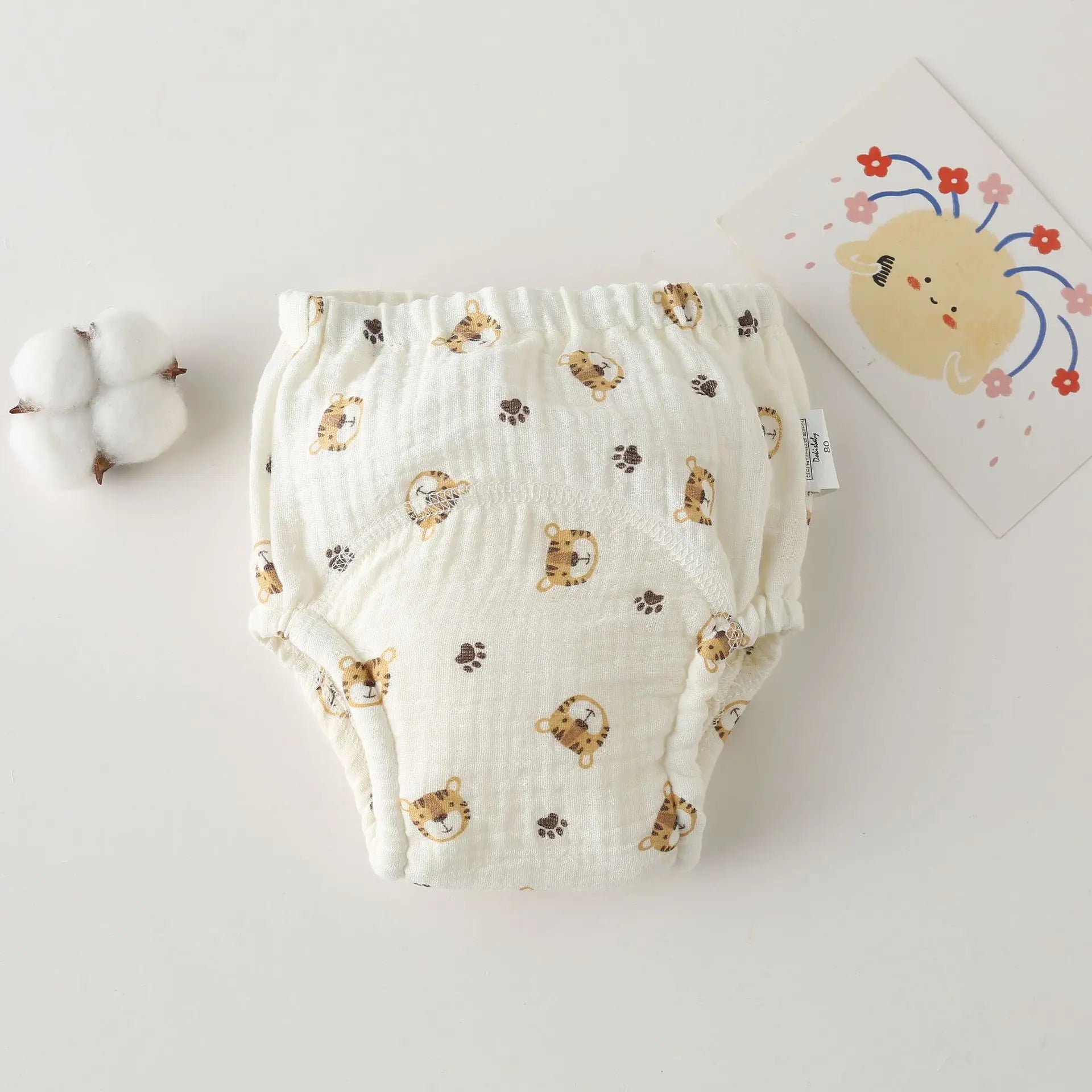 Cotton baby training diaper, size 80, featuring a cute tiger and paw print pattern. Breathable baby care essential.