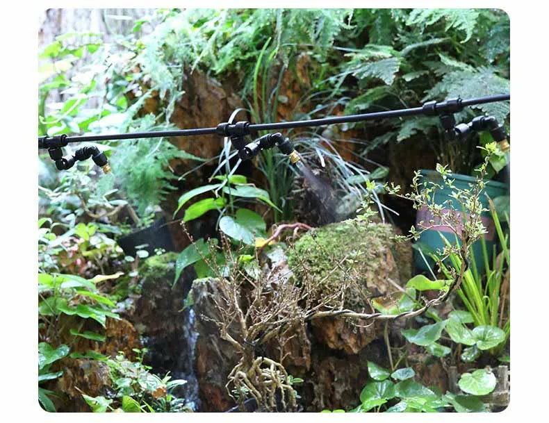 Spray manifold with multiple black tubing lines and mist nozzles for irrigation