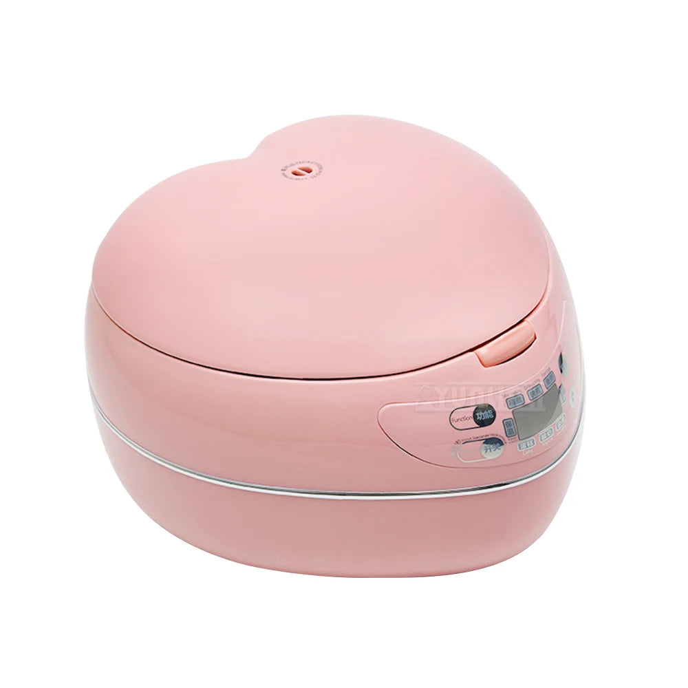 Pink heart-shaped mini rice cooker, closed with visible control buttons on top.