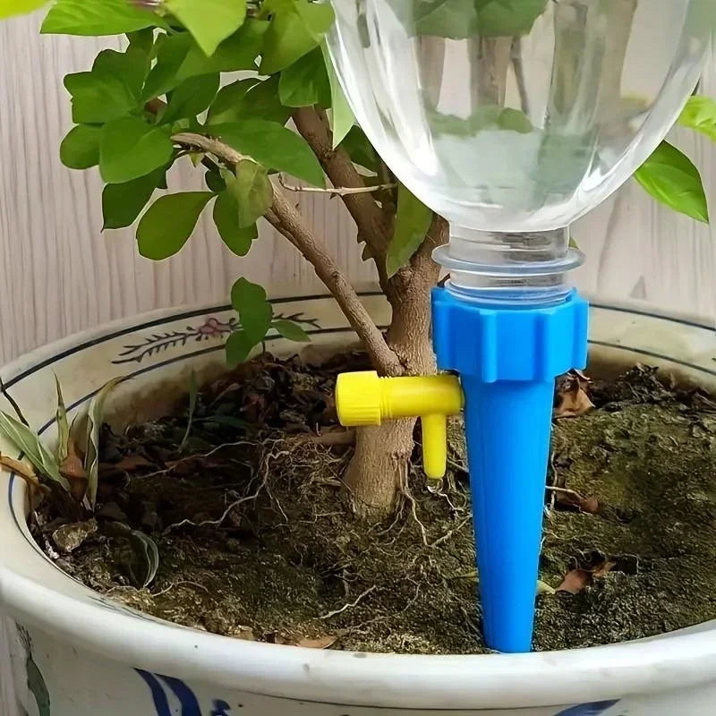 Blue adjustable drip irrigation spike with yellow emitter, standing in planter soil.
