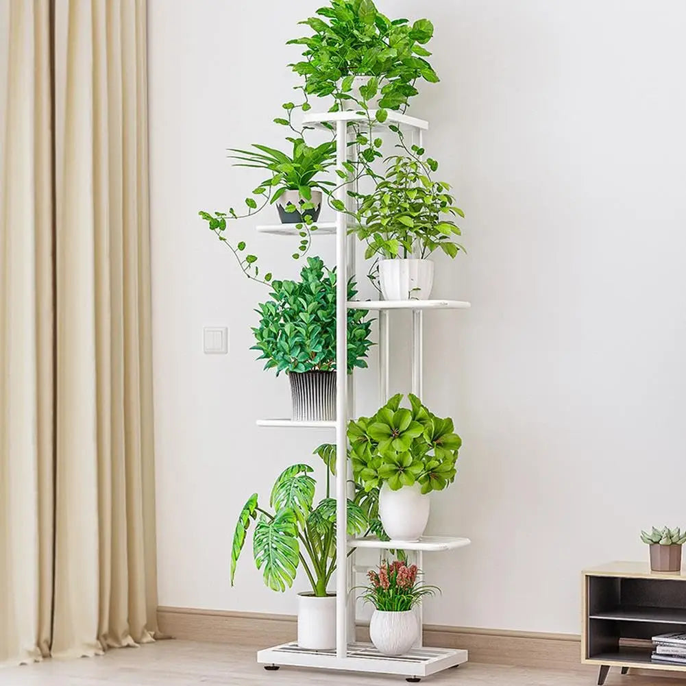 Multi-tier vintage plant display shelf with white frame, several potted plants on shelves