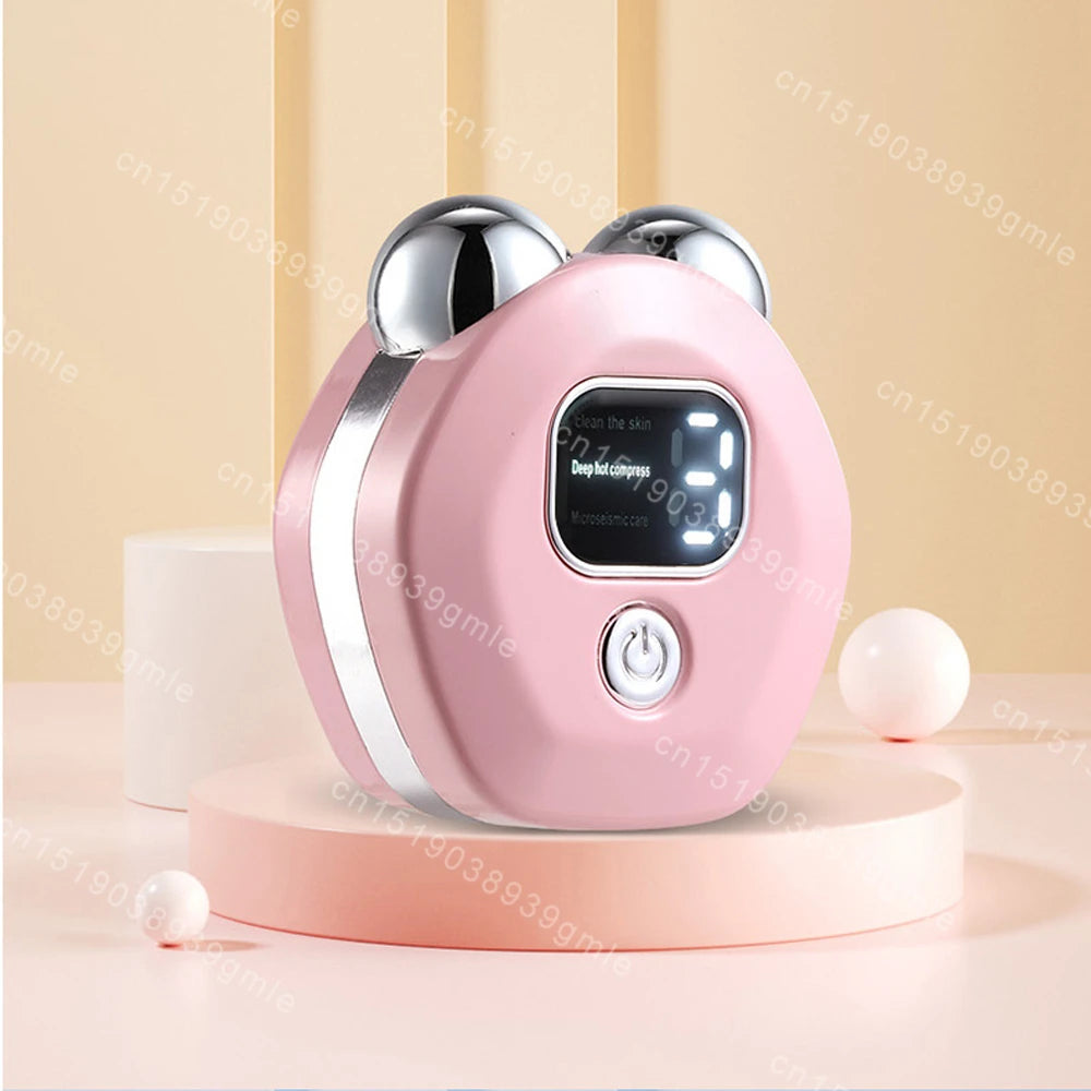 A pink, round facial massager with two metallic rollers, a digital display screen, and a power button on a beige base.