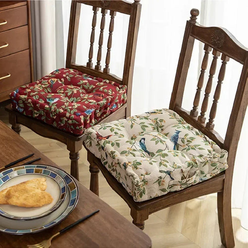 Red and cream fabric square meditation cushions with nature print for mindful seating comfort.