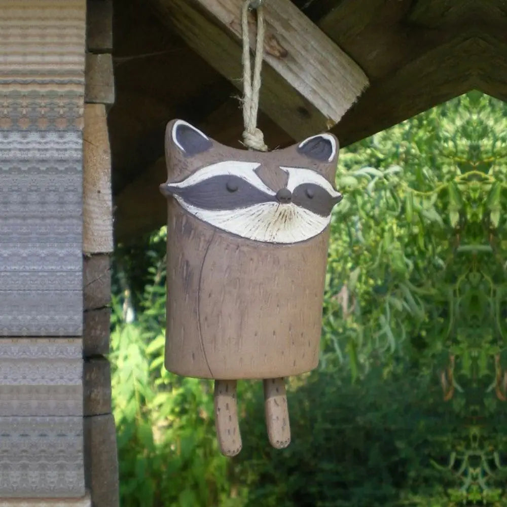 Cute brown resin raccoon wind chime for rustic garden decor, perfect for an outdoor nature-inspired animal gift.