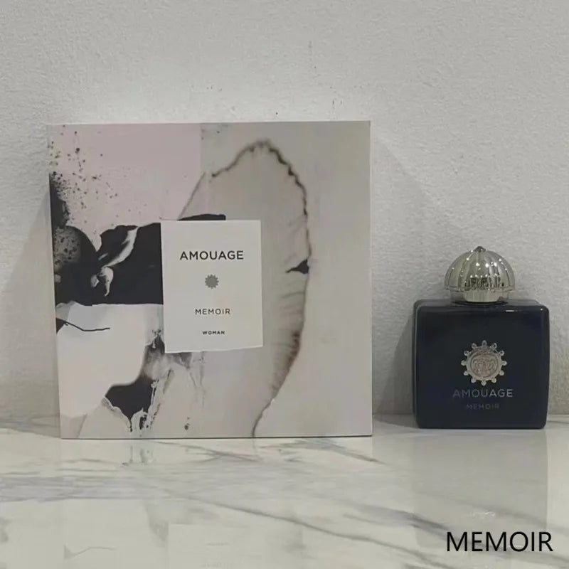 Amouage Memoir Woman EDP: 100ml floral oriental chypre perfume in a sleek dark square bottle with metallic dome cap.