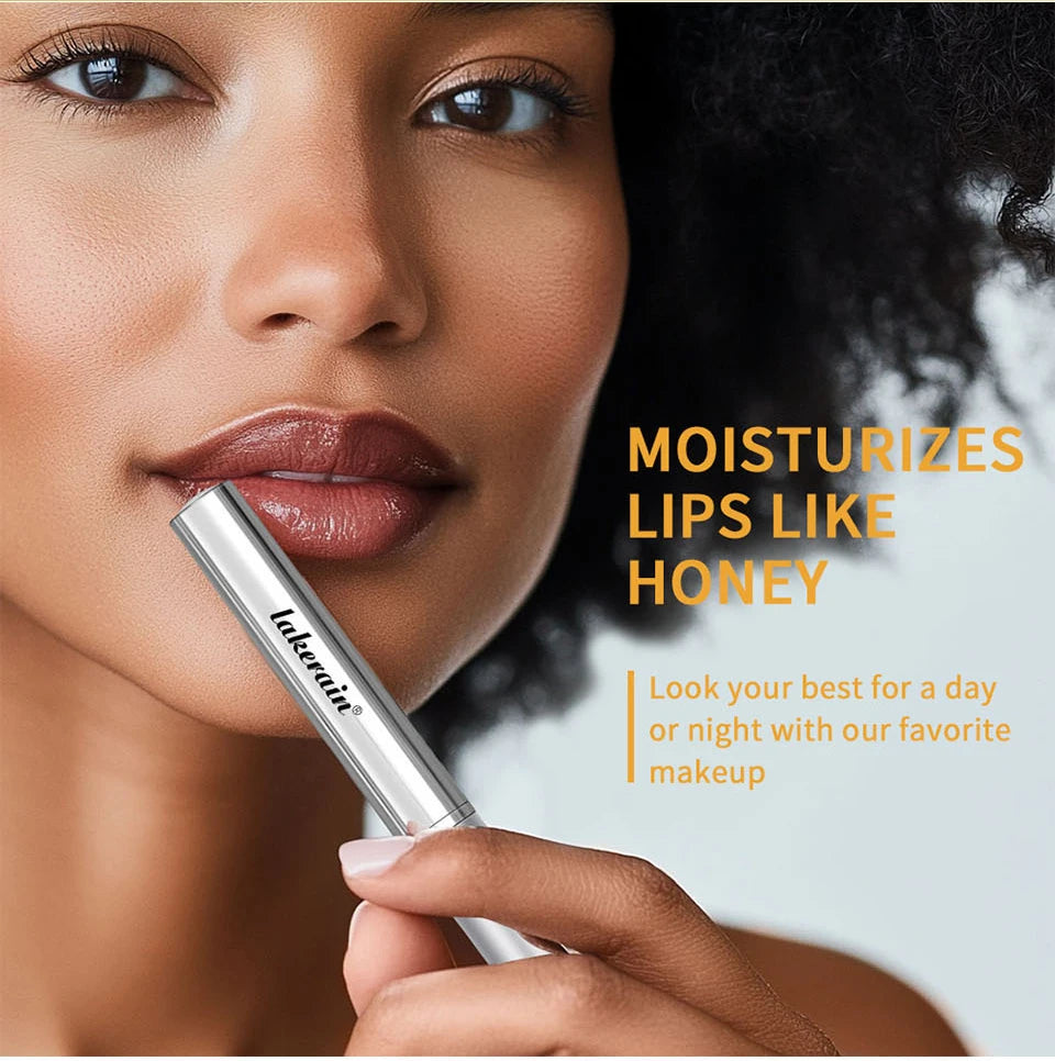Model wearing glossy, nourishing black brown honey-tinted lip balm with a plumping, non-stick finish for hydration.