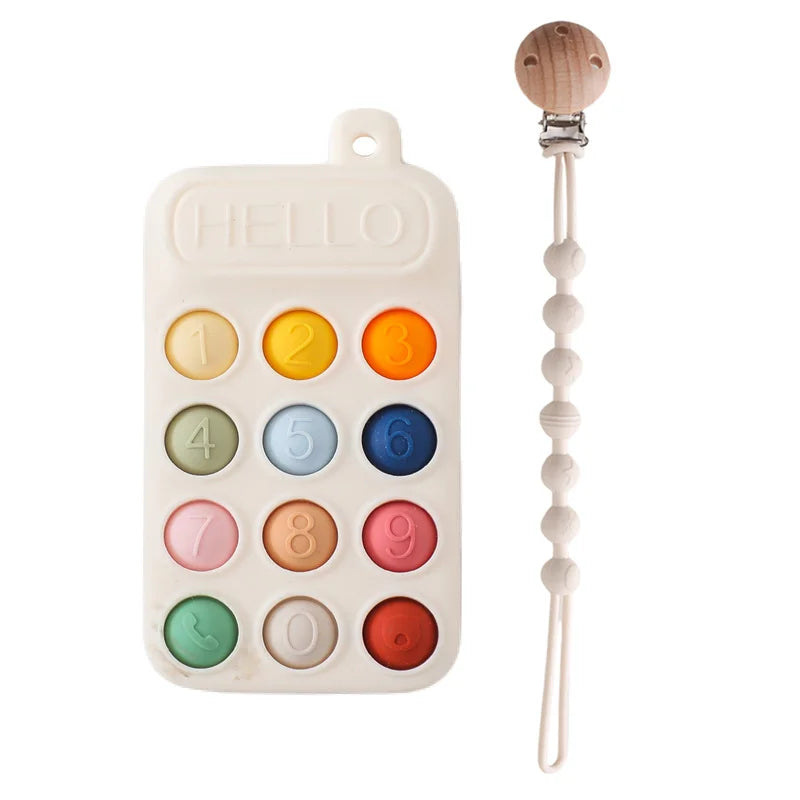 Colorful silicone baby teething toy in phone design with matching pacifier clip.